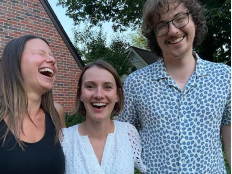 Graduate students, Lauren Laifer, Erin Ramsdell, and Eric Phillips smile for a photo